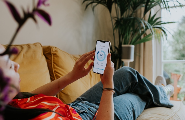 Woman managing heating on app 
