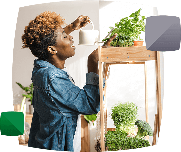 Woman watering plants in home