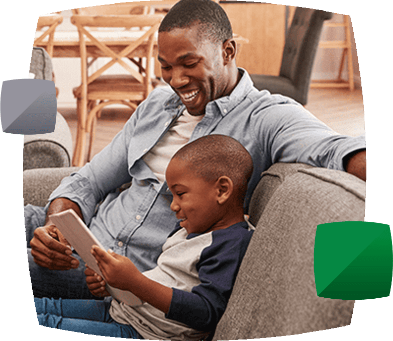 Child sitting on the sofa with parent on phone