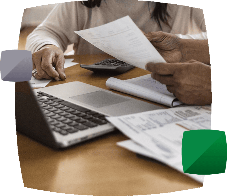 People with calculator, papers and laptop