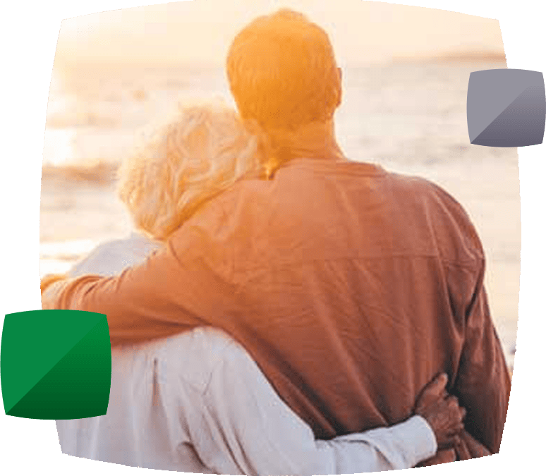 older couple embracing facing away from camera