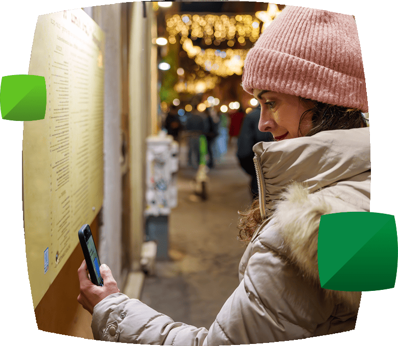 woman scanning QR code outside restaurant
