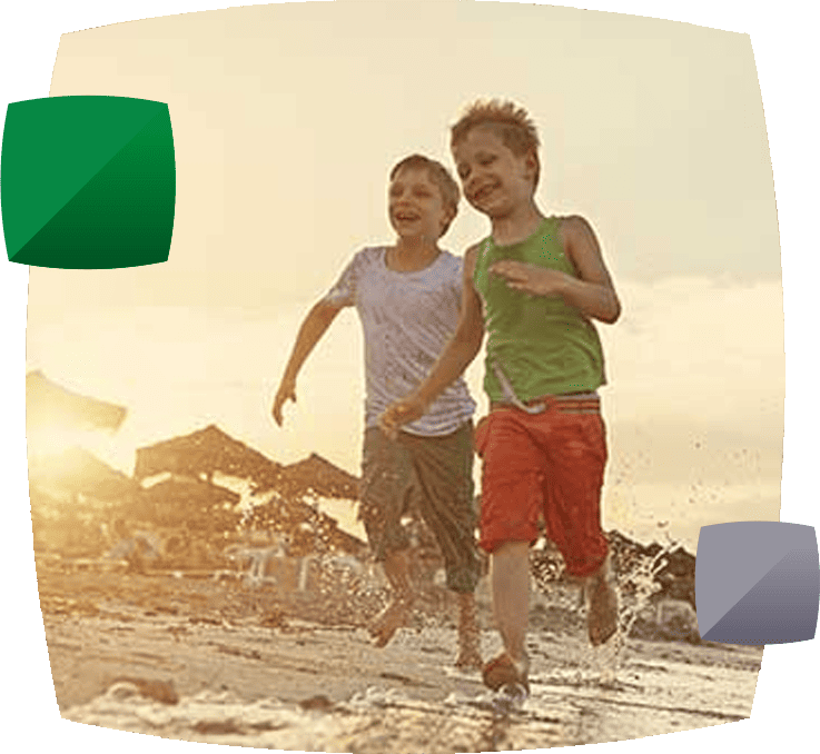 Two boys running on the beach